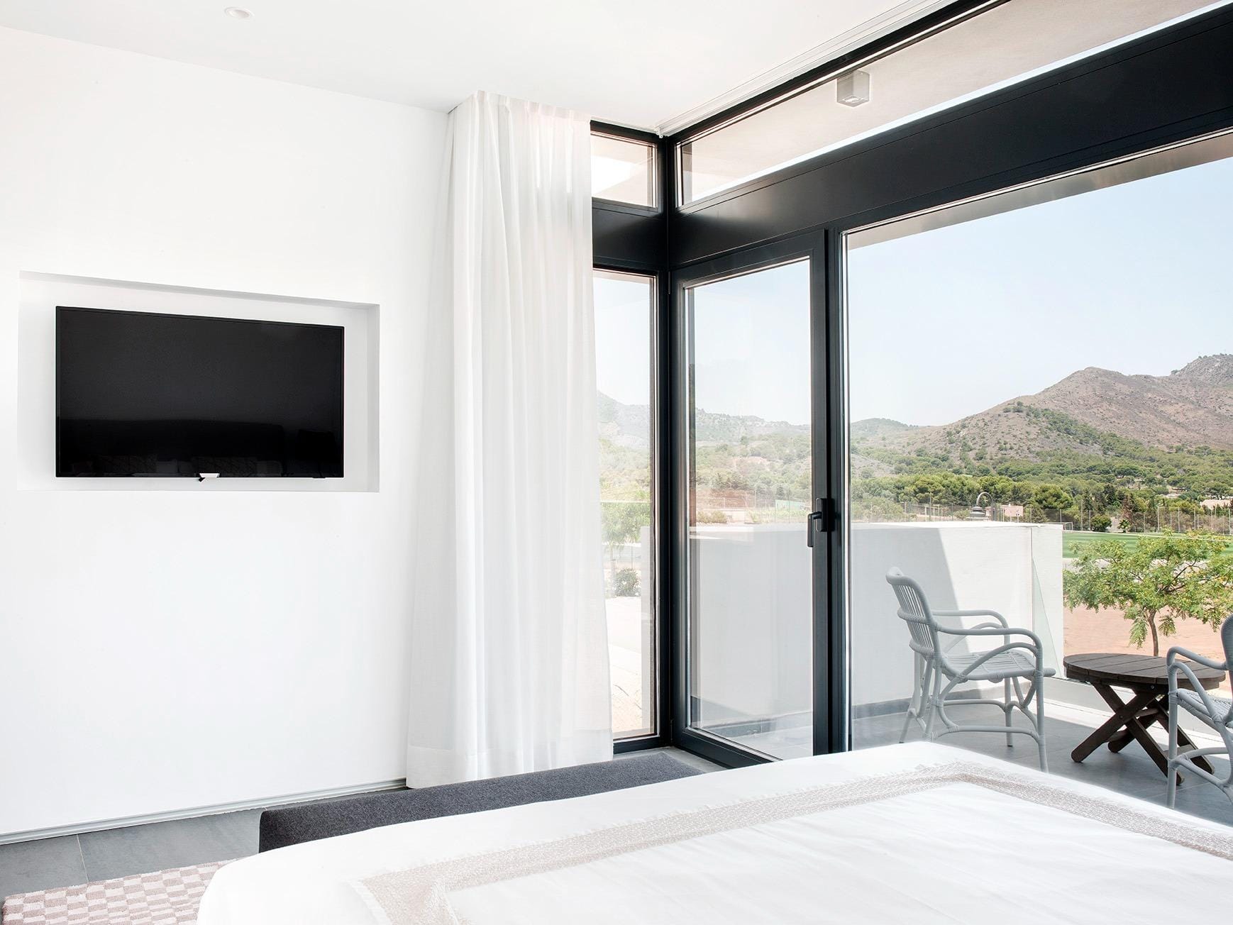 New-Build-Villas-for-Sale-at-La-Manga-Club-–-Luxury-Living-in-a-Prestigious-Resort-16 Bedroom with terrace access and wide hillside views in La Manga Club, Murcia
