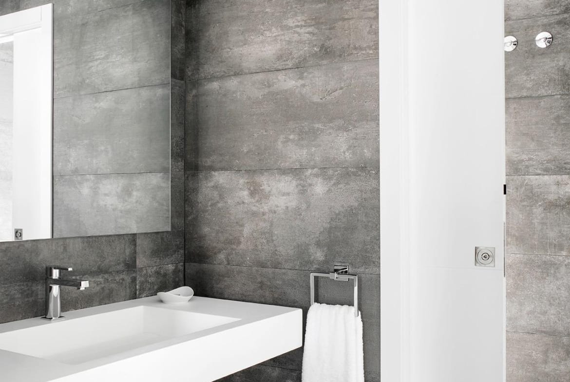 Bathroom vanity with large mirror and dark contemporary tiling in La Manga Club, Murcia