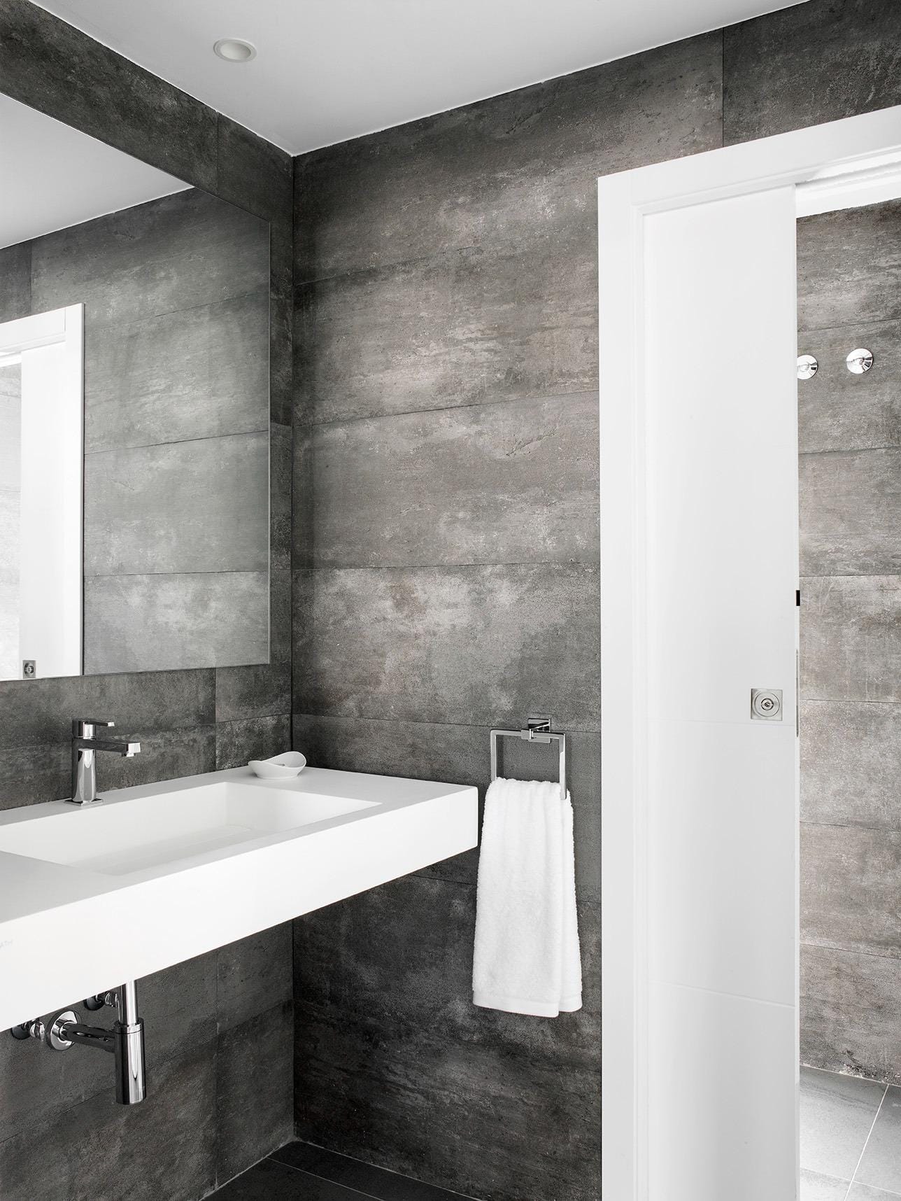 New-Build-Villas-for-Sale-at-La-Manga-Club-–-Luxury-Living-in-a-Prestigious-Resort-20 Bathroom vanity with large mirror and dark contemporary tiling in La Manga Club, Murcia