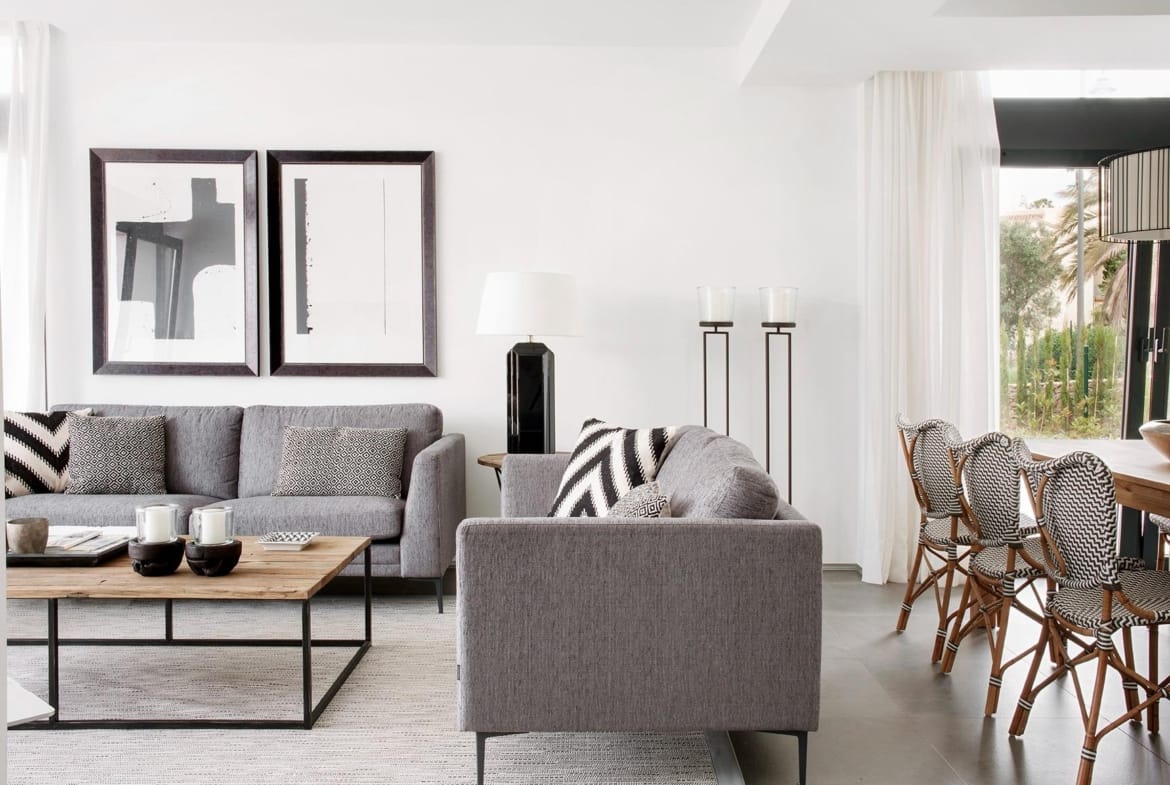 Bright open-plan living and dining area with grey sofas and neutral styling in La Manga Club, Murcia