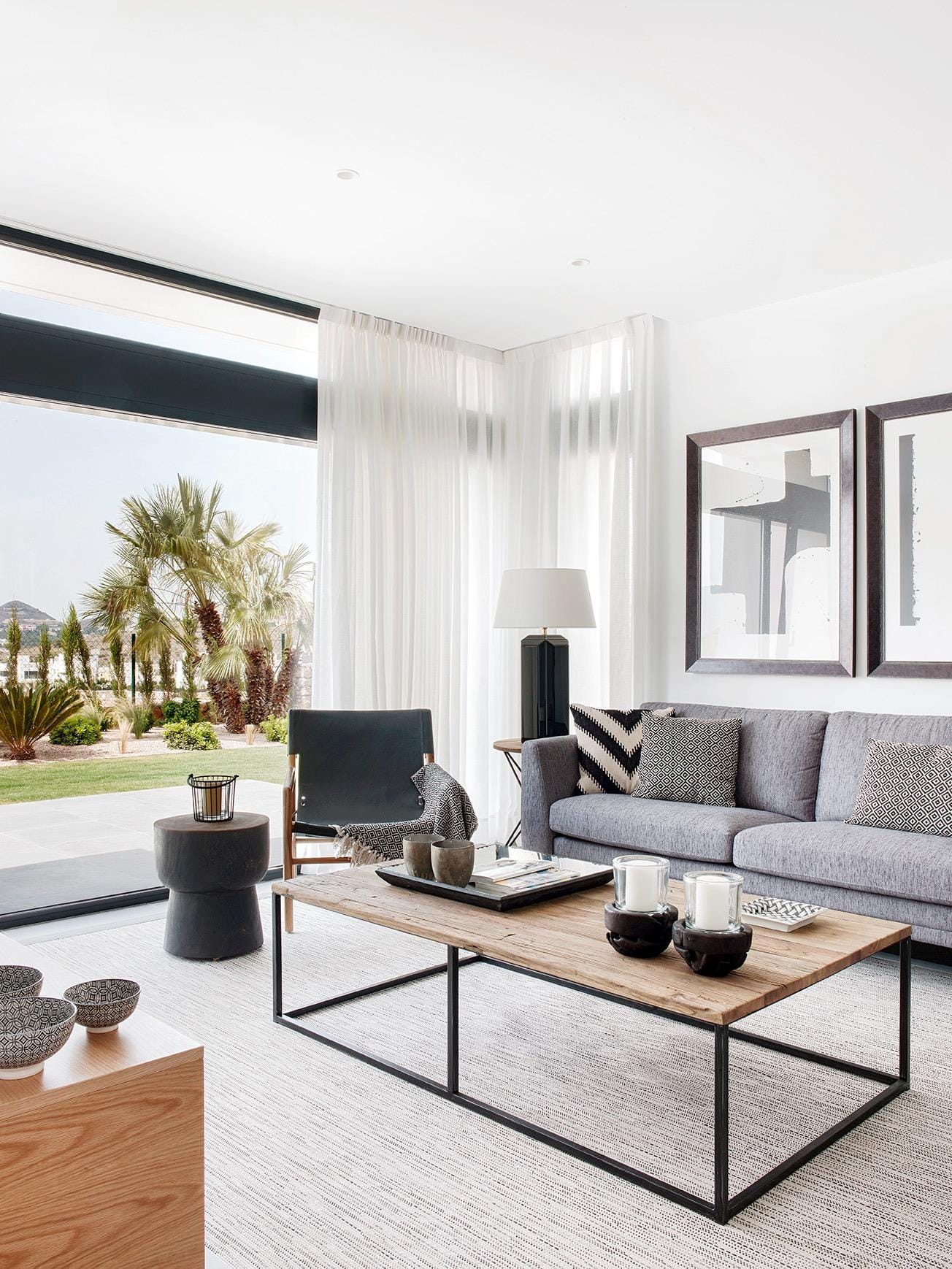 New-Build-Villas-for-Sale-at-La-Manga-Club-–-Luxury-Living-in-a-Prestigious-Resort-5 Living room with large sliding doors and a bright garden-facing corner in La Manga Club, Murcia