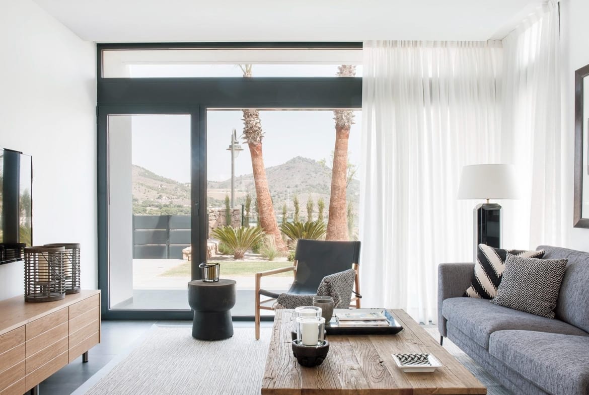 Living room with full-height glazing and hillside outlook in La Manga Club, Murcia