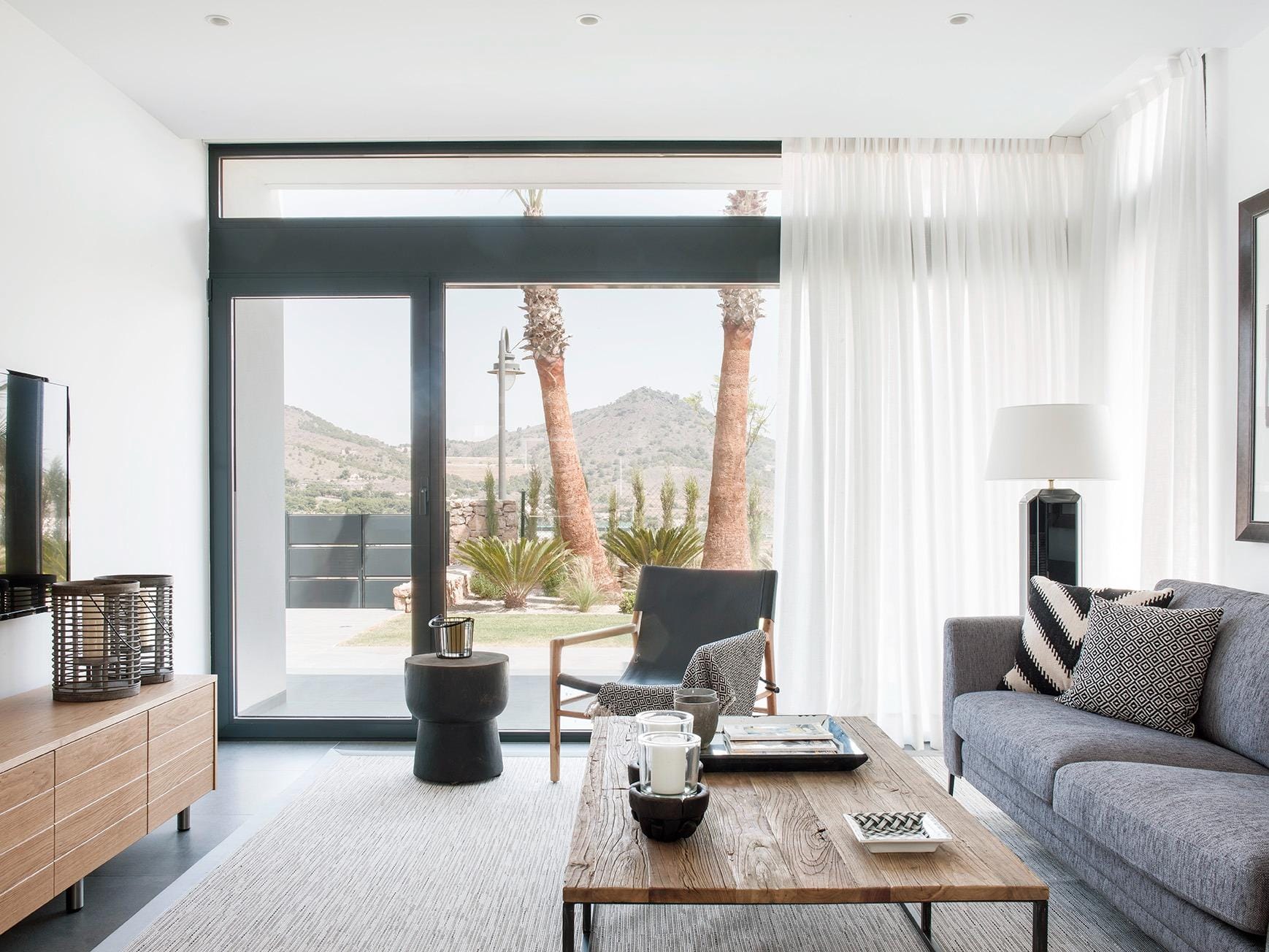 New-Build-Villas-for-Sale-at-La-Manga-Club-–-Luxury-Living-in-a-Prestigious-Resort-6 Living room with full-height glazing and hillside outlook in La Manga Club, Murcia
