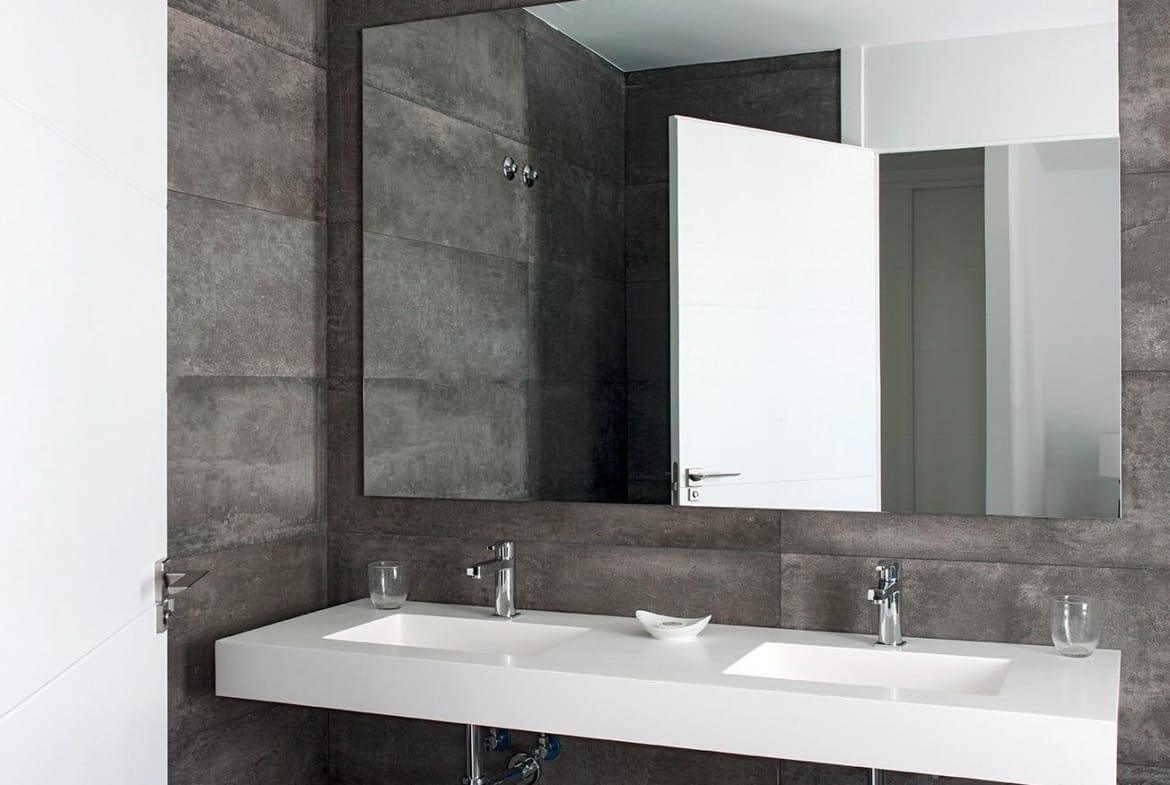 Contemporary bathroom with double vanity and dark stone-effect wall tiles in La Manga Club, Murcia