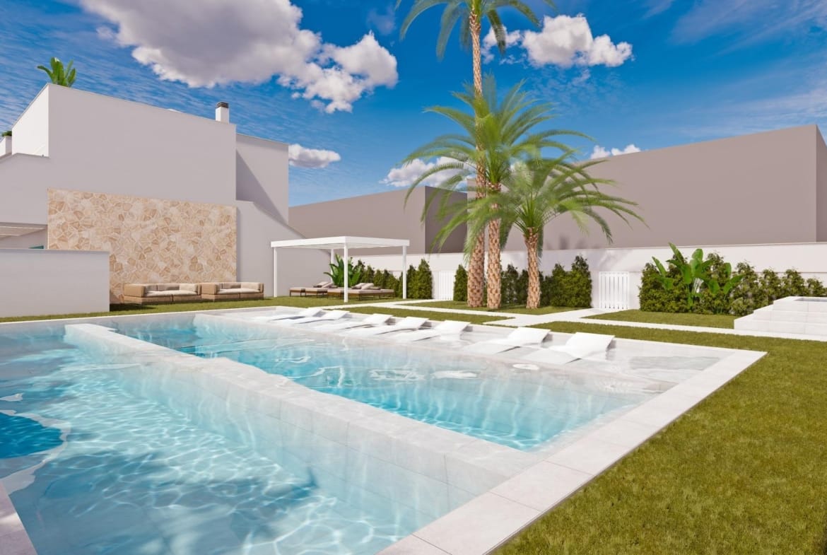 Swimming pool beside lawns, palms and white residential buildings in Torre de la Horadada, Alicante