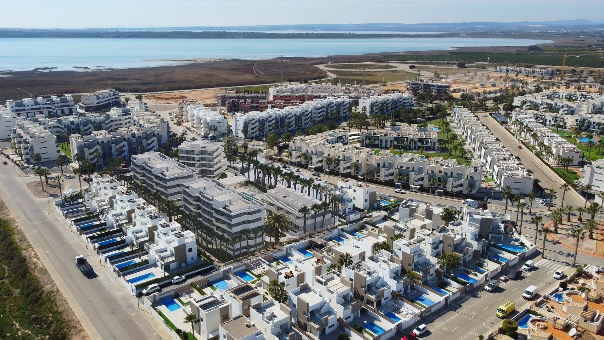 Aerial view of the residential neighbourhood and nearby lagoon in El Raso, Guardamar del Segura, Alicante