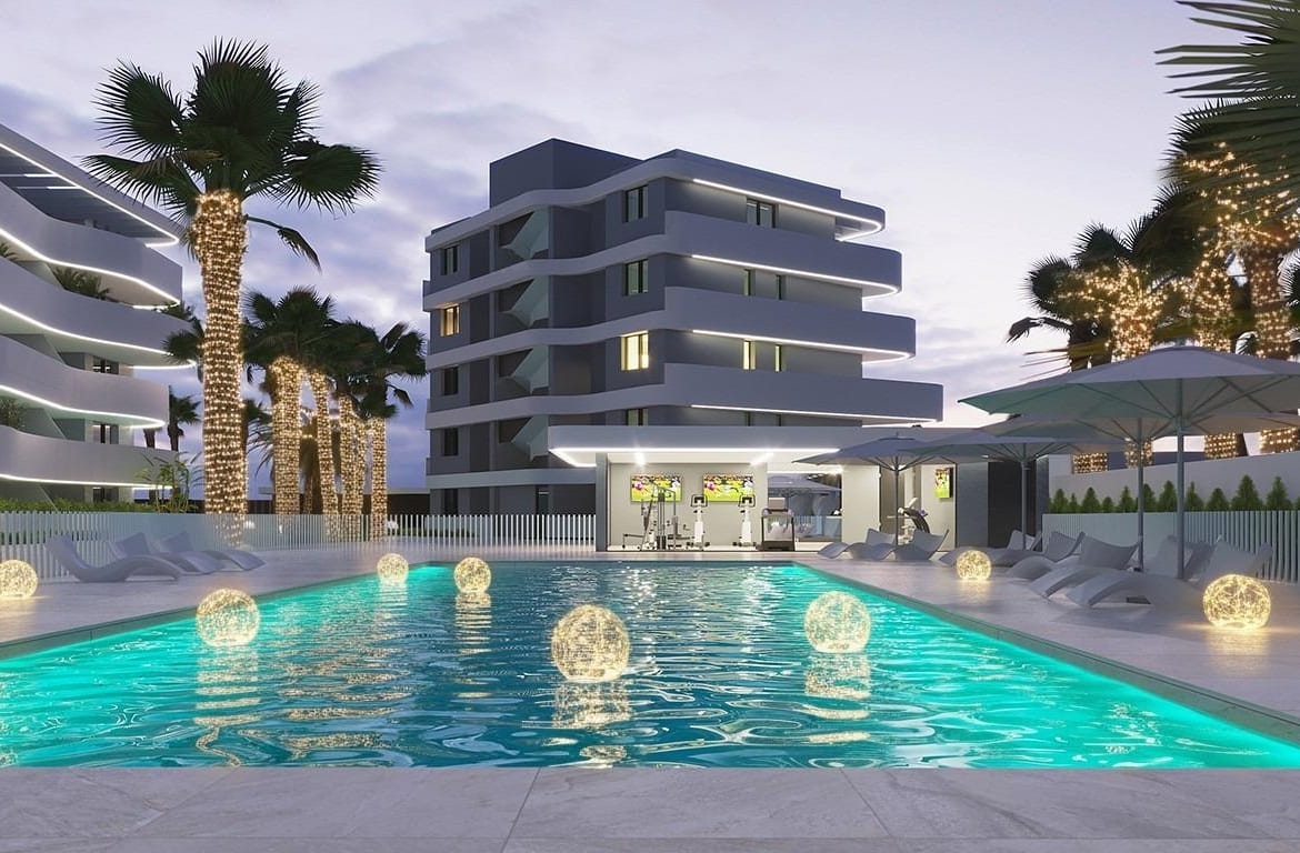Evening rendering of a lit communal pool framed by apartment buildings and palm trees in El Raso, Guardamar del Segura, Alicante