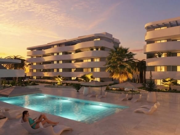 Evening rendering of an illuminated communal pool beside curved white apartment buildings in El Raso, Guardamar del Segura, Alicante