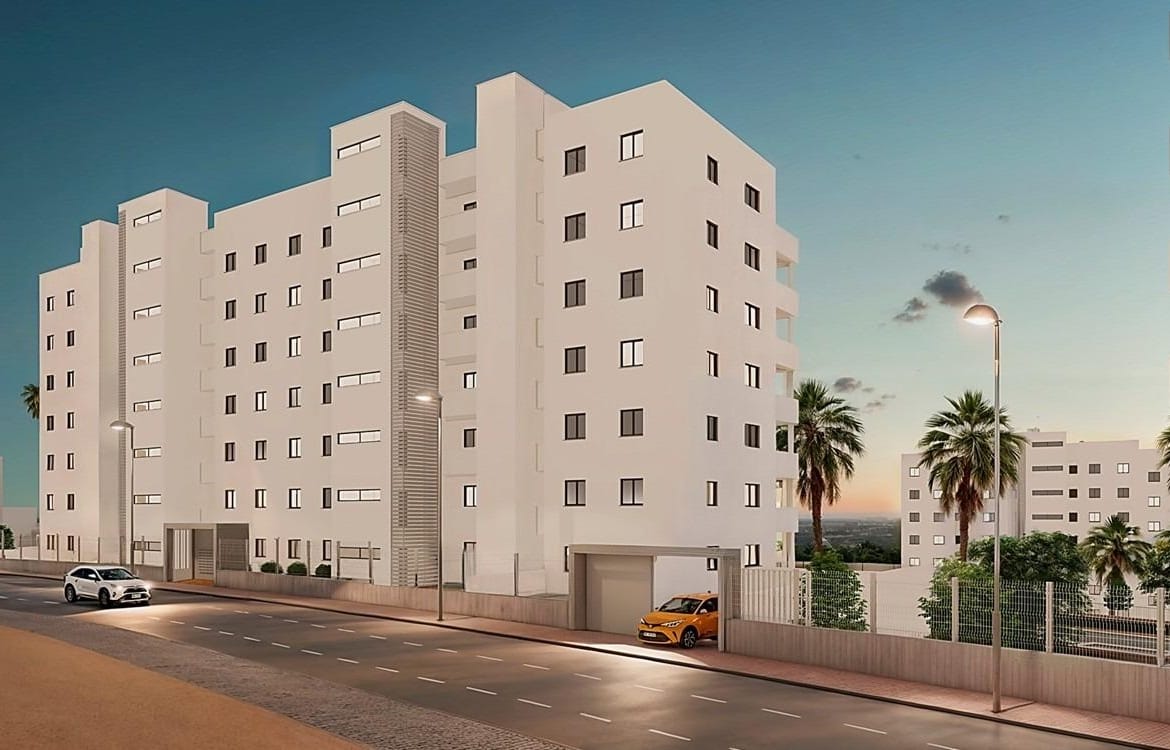 Street-facing development rendering showing the apartment facades at dusk in San Miguel de Salinas, Alicante