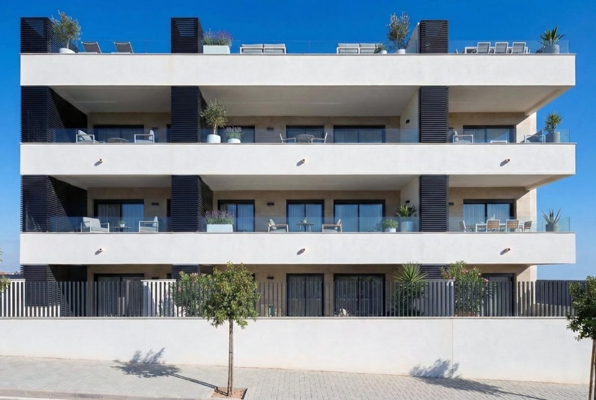 Front elevation rendering of apartments with glass-fronted terraces and street trees in Benijófar, Alicante