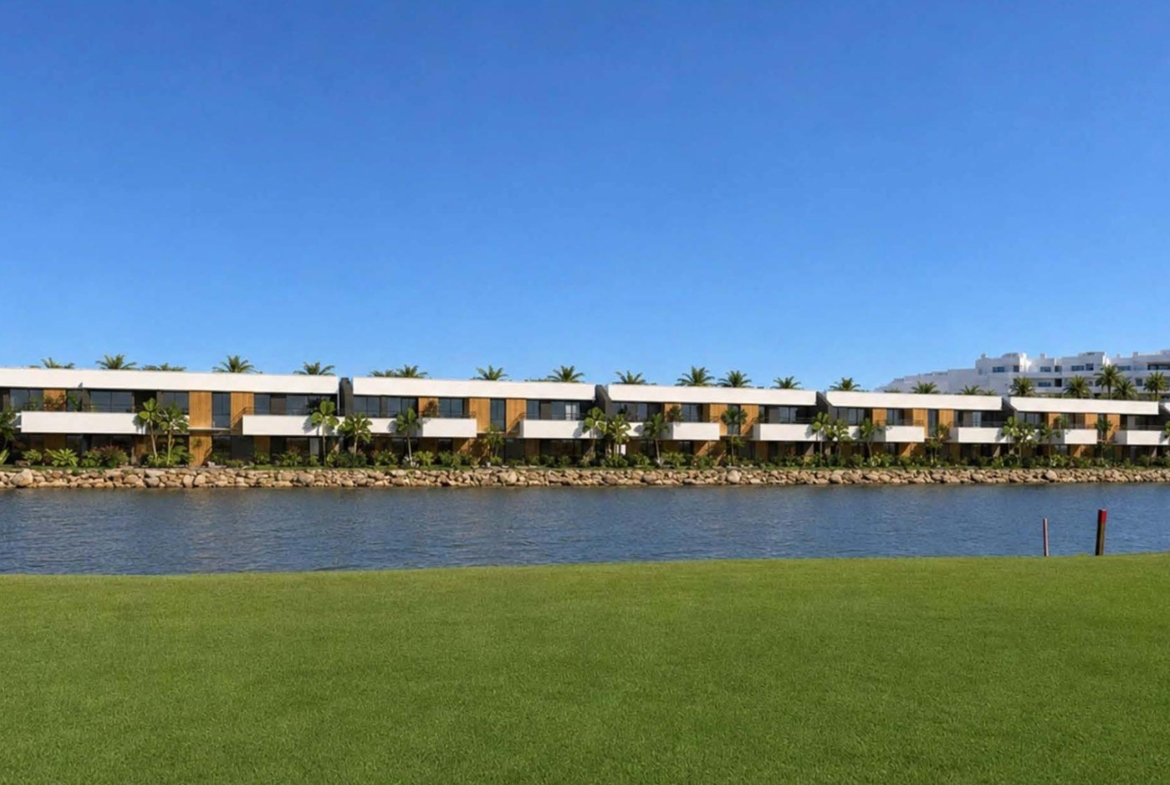 Golf-side apartment buildings beside the lake in Condado de Alhama Golf Resort