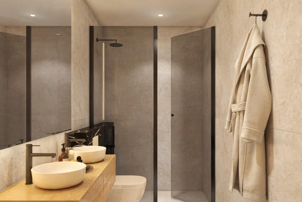 Modern apartment bathroom with walk-in shower and double vanity at Condado de Alhama Golf Resort
