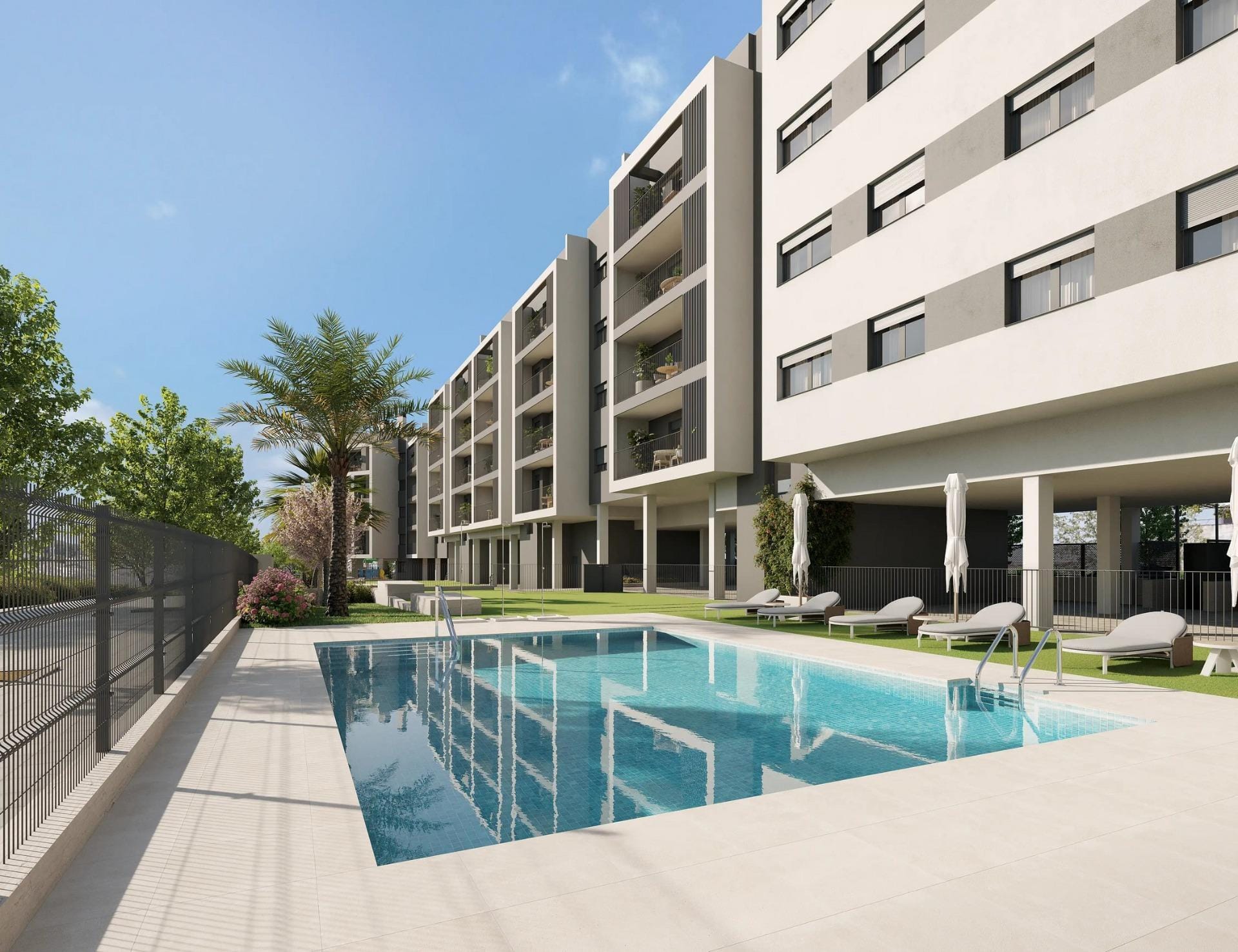 with open views of the city. Communal swimming pool with sun loungers beside apartment balconies in San Agustín, Alicante