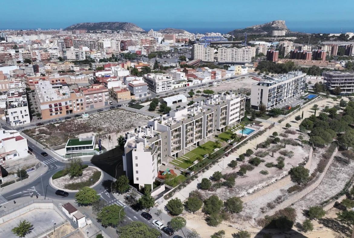 Aerial view of the residential complex with communal pool and Alicante skyline in San Agustín, Alicante