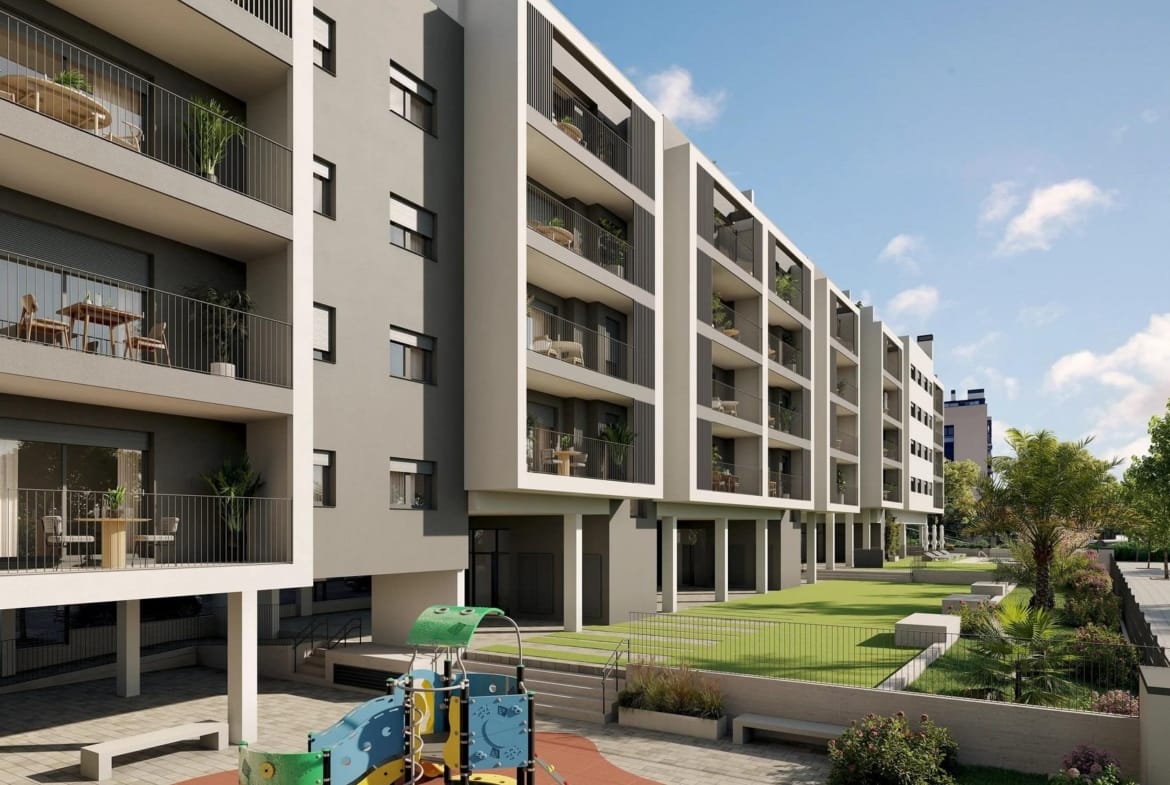 Apartment balconies above gardens and a children’s play area in San Agustín, Alicante