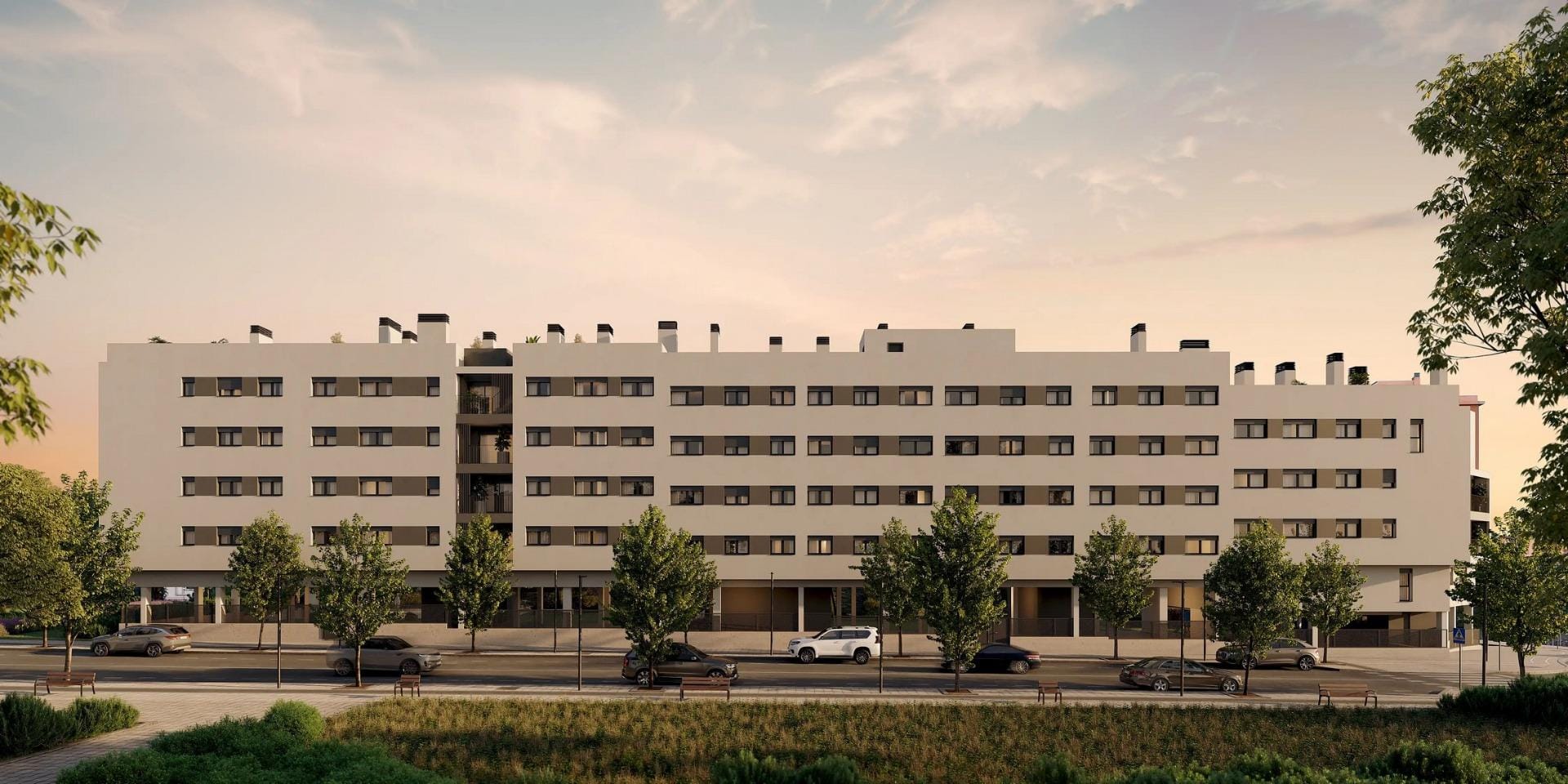 Newly-built-residential-development-in-Alicante-with-open-views-of-the-city-4 Long apartment façade and tree-lined street at dusk in San Agustín, Alicante