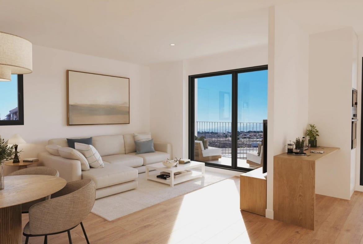 Living and dining room with white sofa and terrace doors in San Agustín, Alicante
