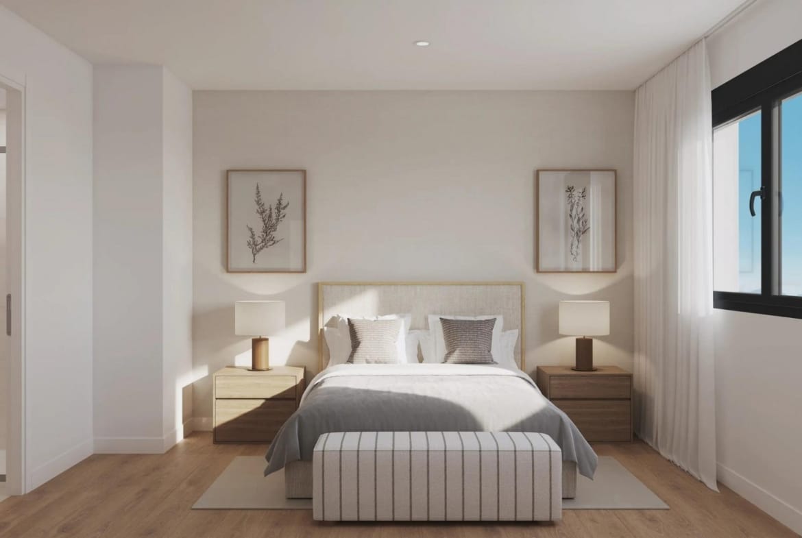 Double bedroom with bedside tables and an adjoining bathroom in San Agustín, Alicante