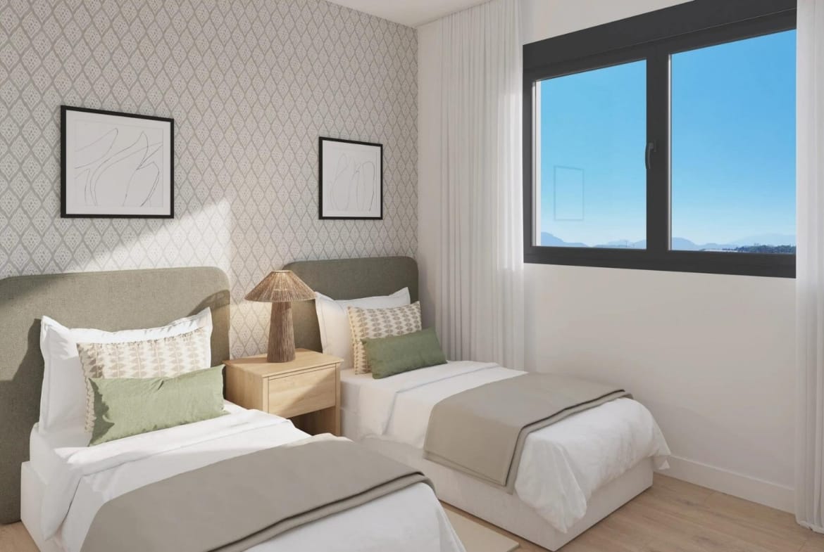 Twin bedroom with patterned wallpaper and green cushions in San Agustín, Alicante