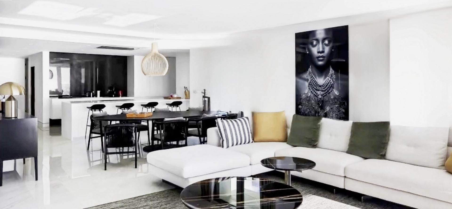 Residential-complex-in-Relleu-with-communal-swimming-pool-and-open-views-1 Living and dining area with a white sofa, dark dining chairs and pendant lighting in Relleu, Alicante