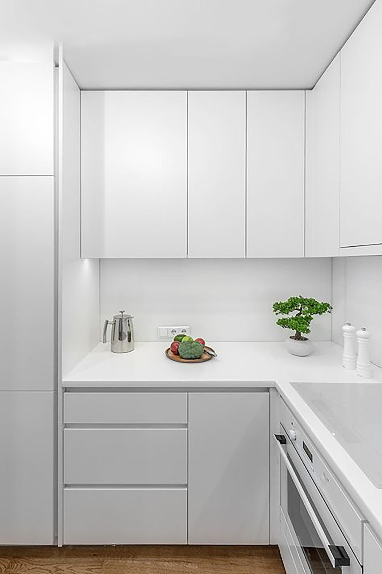 Residential-complex-in-Relleu-with-communal-swimming-pool-and-open-views-4 Kitchen corner with white cupboards, a pale worktop and a potted plant in Relleu, Alicante