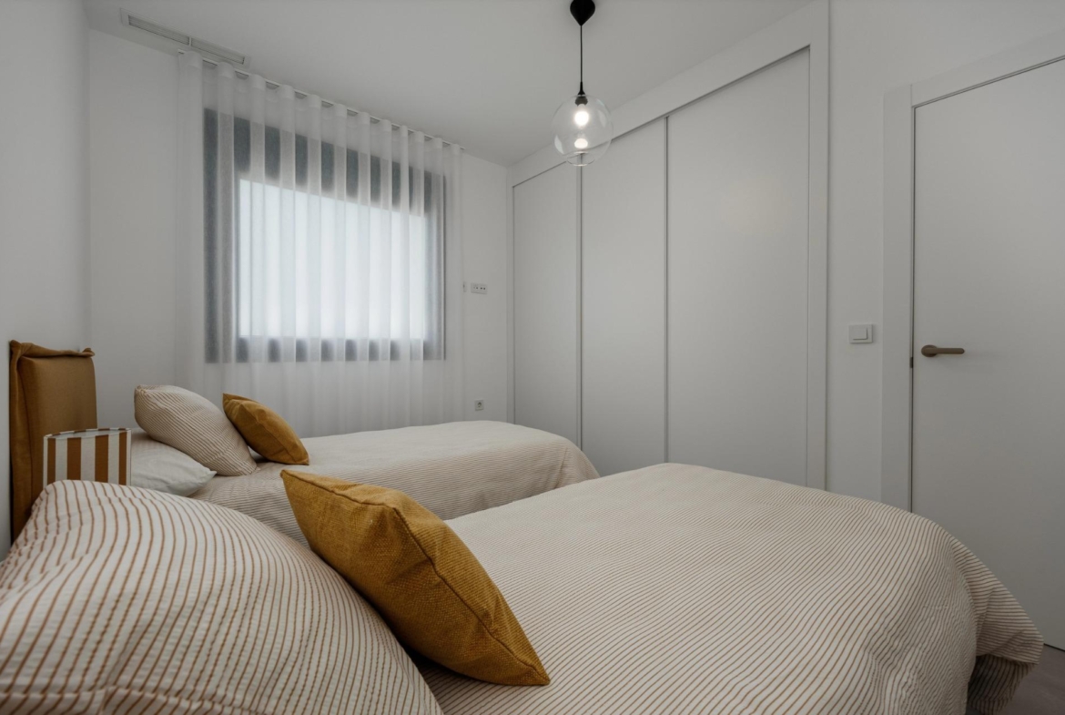 Unique-Investment-Opportunity-in-Villajoyosa-Costa-Blanca-North-15 Twin bedroom with fitted wardrobes