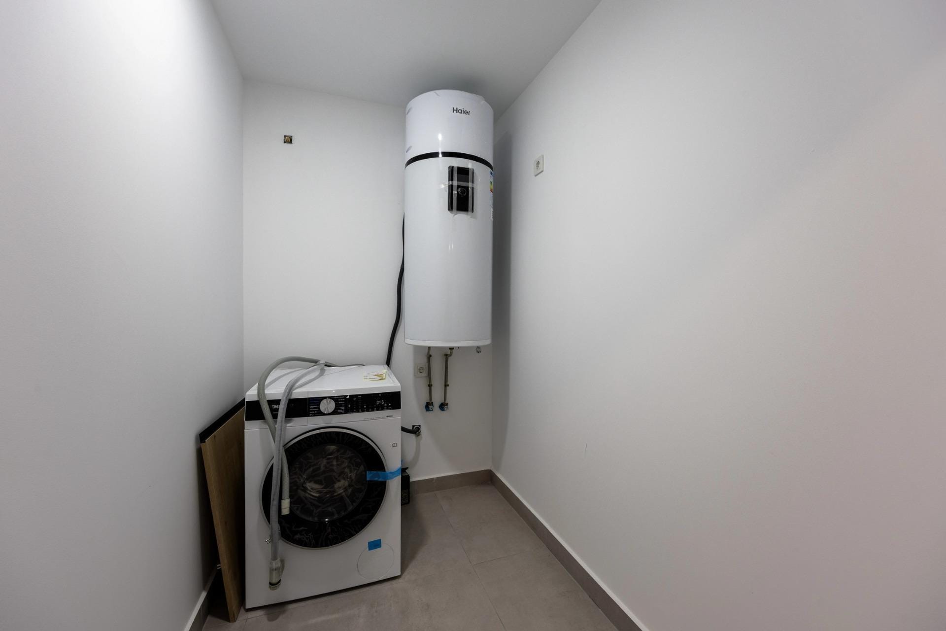 Unique-Investment-Opportunity-in-Villajoyosa-Costa-Blanca-North-18 Laundry room with washing machine and hot-water cylinder