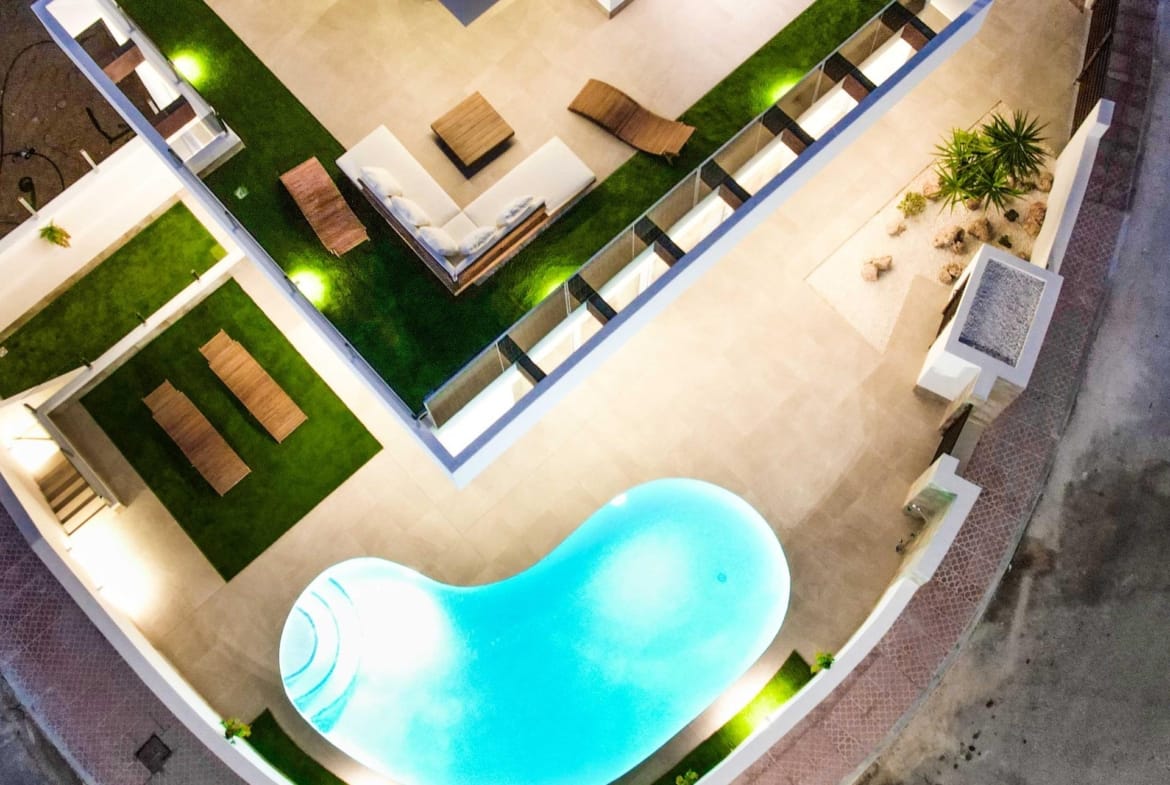 Overhead evening view of the villa and curved pool terrace in La Marquesa, Ciudad Quesada, Alicante