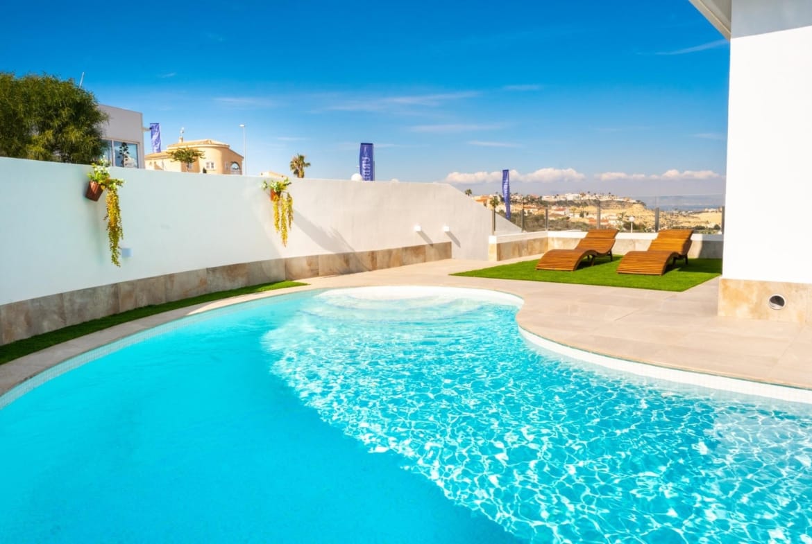 Curved private swimming pool beside the villa terrace in La Marquesa, Ciudad Quesada, Alicante