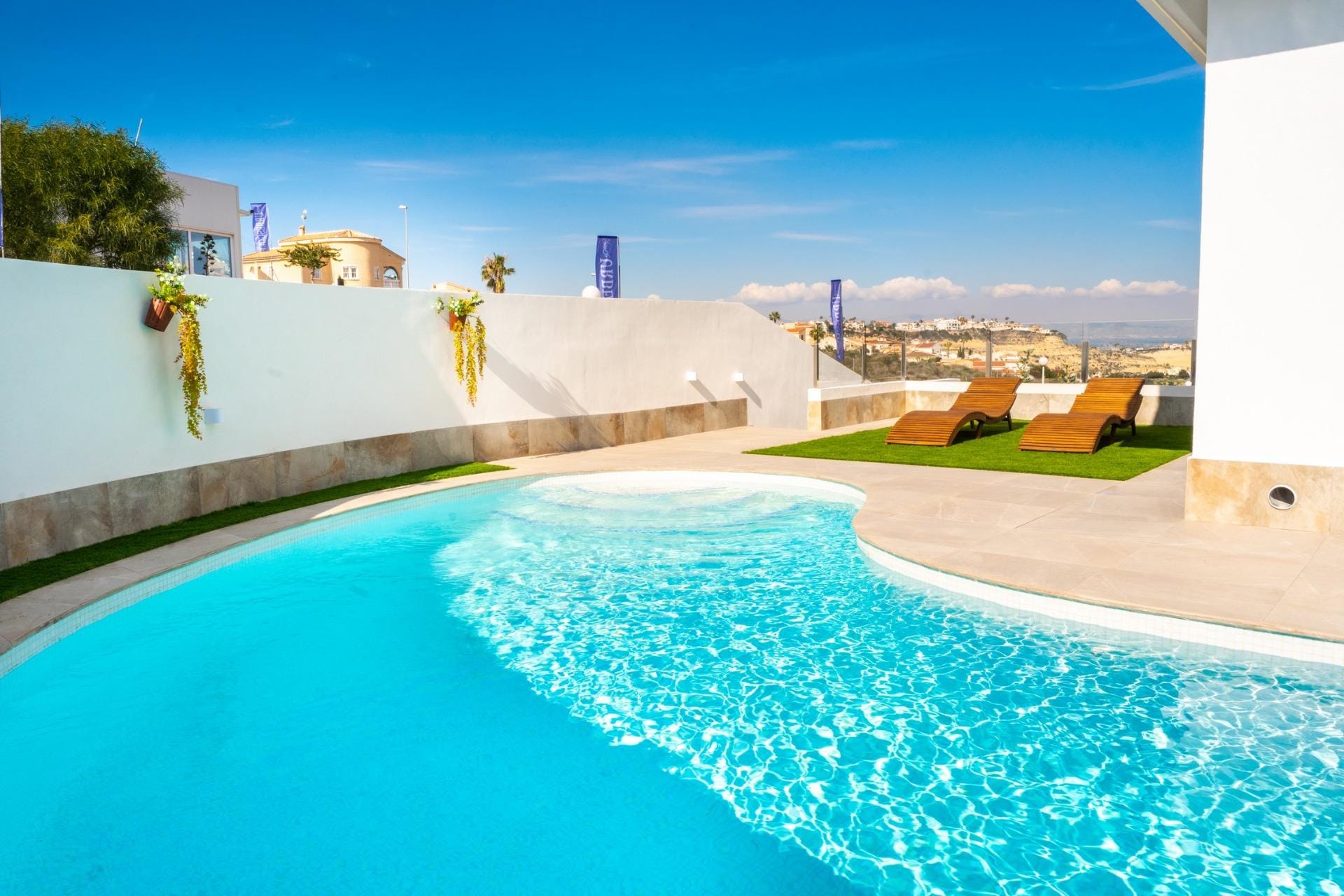 Curved private swimming pool beside the villa terrace in La Marquesa, Ciudad Quesada, Alicante