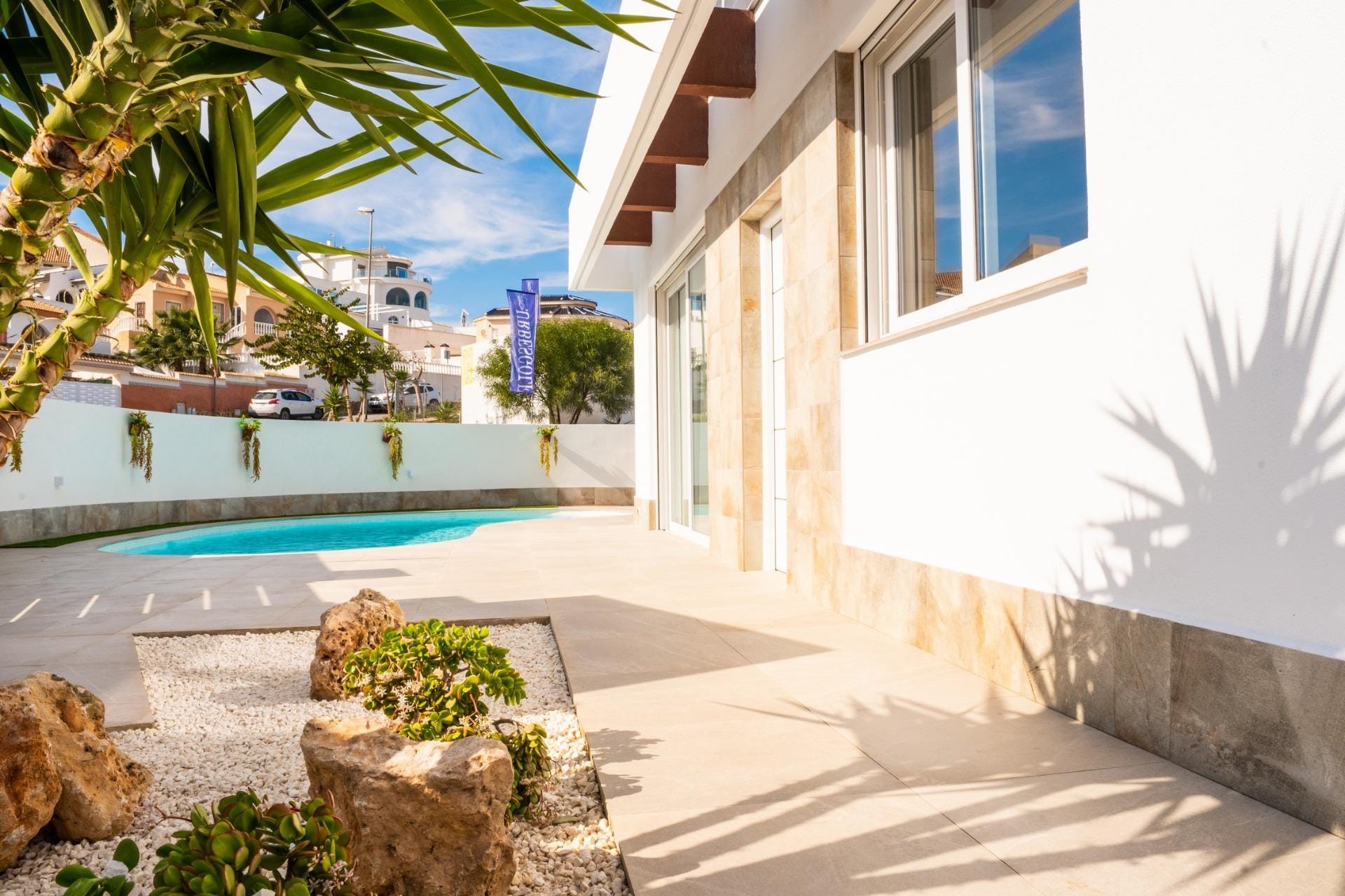 Private pool terrace beside the villa and its glazed living area in La Marquesa, Ciudad Quesada, Alicante