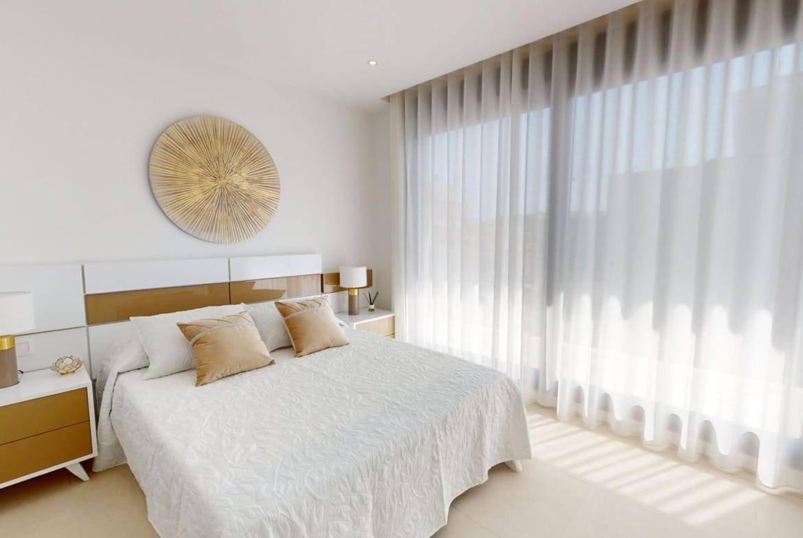 Example bedroom with a double bed and full-height curtains in La Marina, San Fulgencio, Alicante