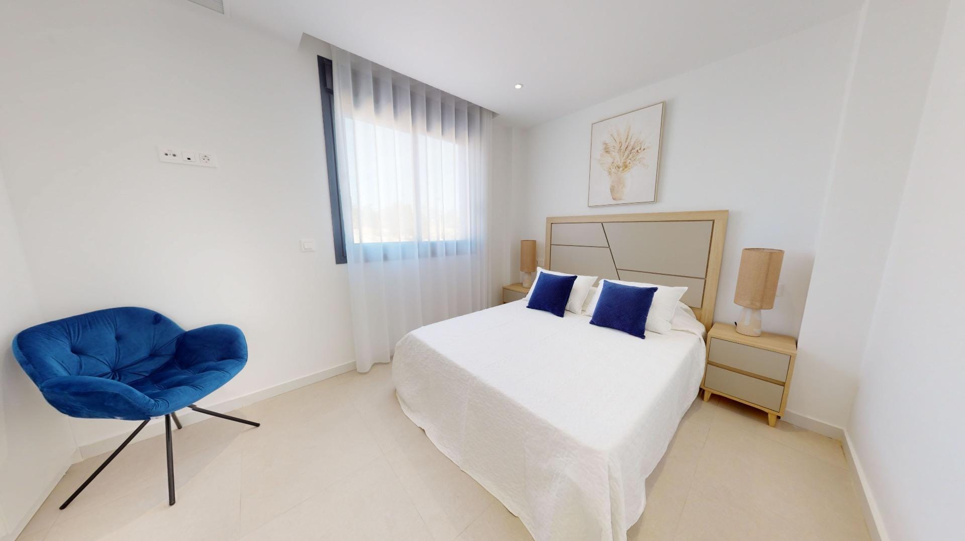 Example bedroom with a blue chair beside the bed in La Marina, San Fulgencio, Alicante