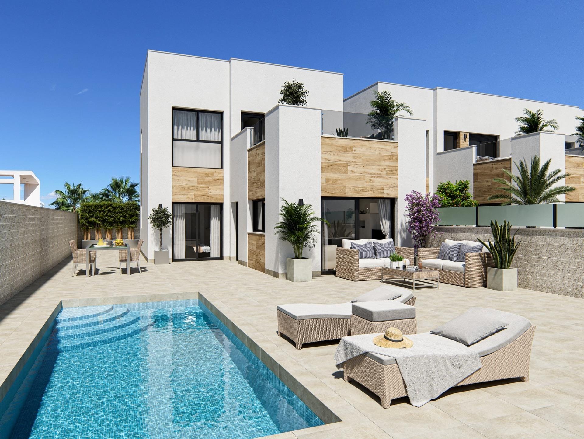 Private swimming pool and outdoor seating beside the villa in Oasis La Marina, San Fulgencio, Alicante