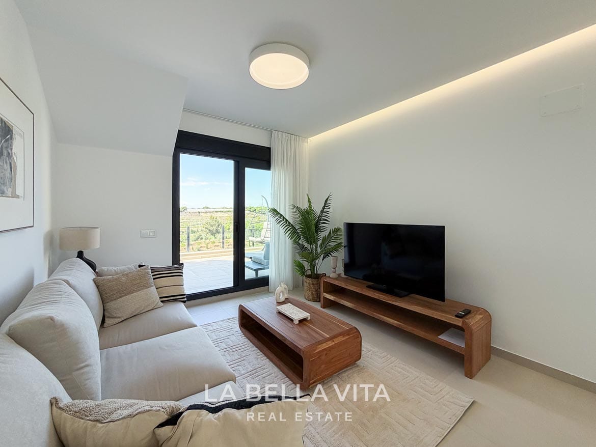 Modern Resale Apartment fot sale in Lo Romero Golf, Pilar de la Horadada, Alicante-10 Living room seating beside the terrace doors, with a wooden coffee table and TV unit