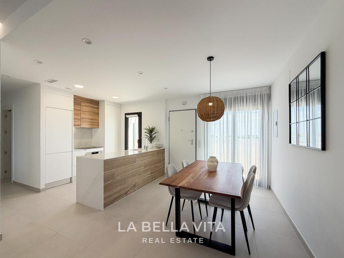 Modern Resale Apartment fot sale in Lo Romero Golf, Pilar de la Horadada, Alicante-13 Dining area with four upholstered chairs beside the kitchen peninsula and entrance