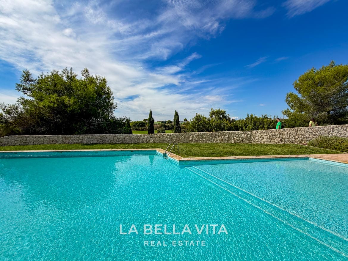 Modern Resale Apartment fot sale in Lo Romero Golf, Pilar de la Horadada, Alicante-44 Communal pool with a shallow section, grass border and mature trees beyond the stone wall