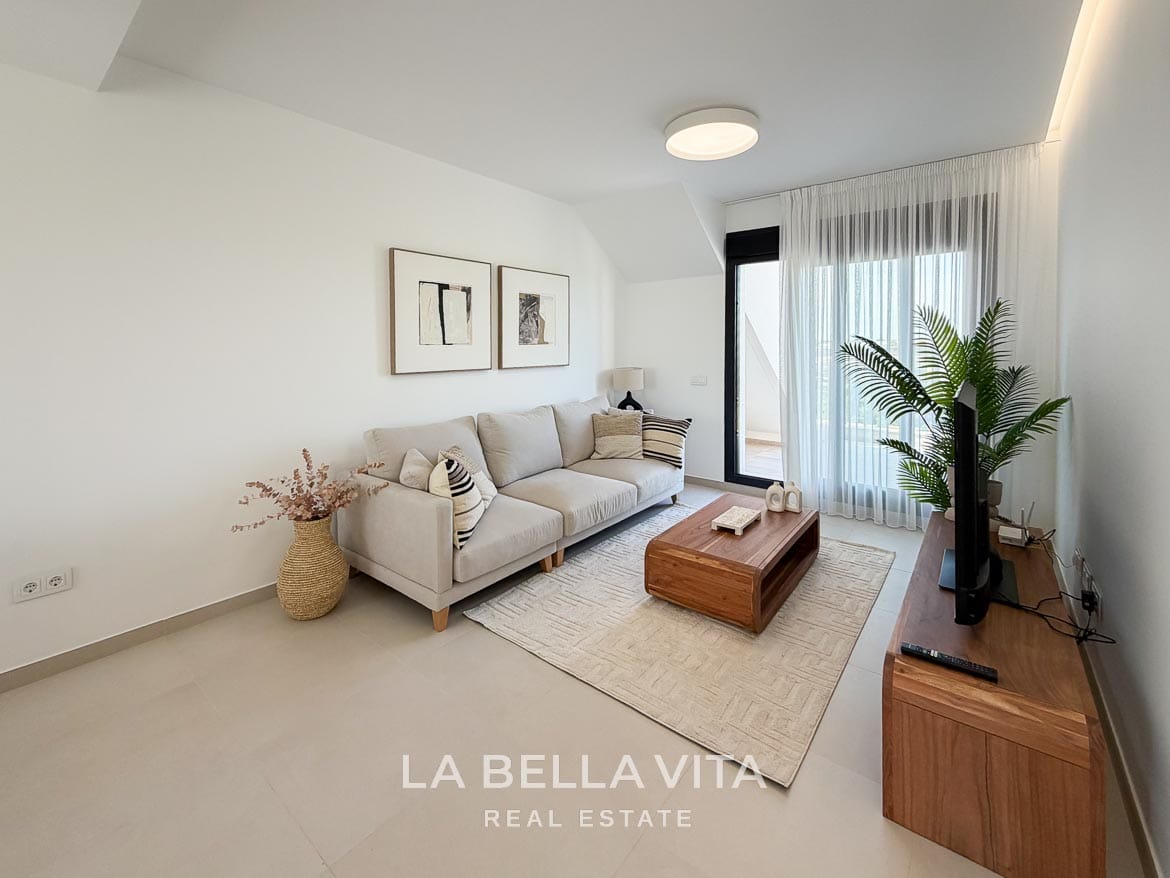 Modern Resale Apartment fot sale in Lo Romero Golf, Pilar de la Horadada, Alicante-6 Bright living room with a cream sofa, wooden coffee table and sliding doors to the terrace