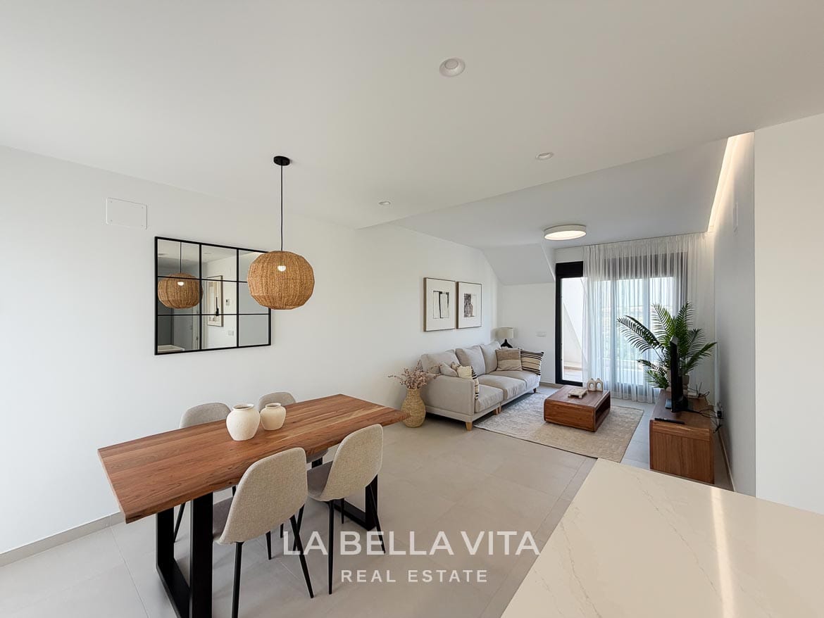 Modern Resale Apartment fot sale in Lo Romero Golf, Pilar de la Horadada, Alicante-8 Open-plan dining and living room with a wooden table, woven pendant light and terrace doors