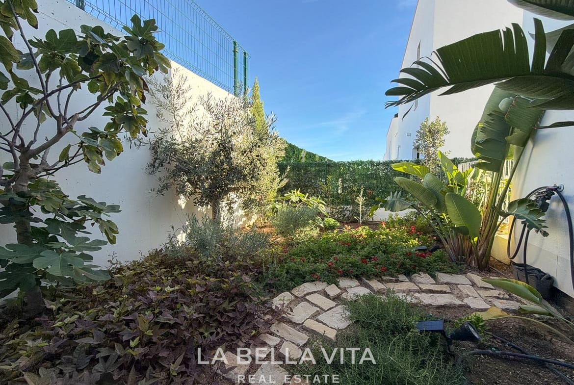 Landscaped garden corner with stepping stones, shrubs and trees in Finestrat, Alicante.