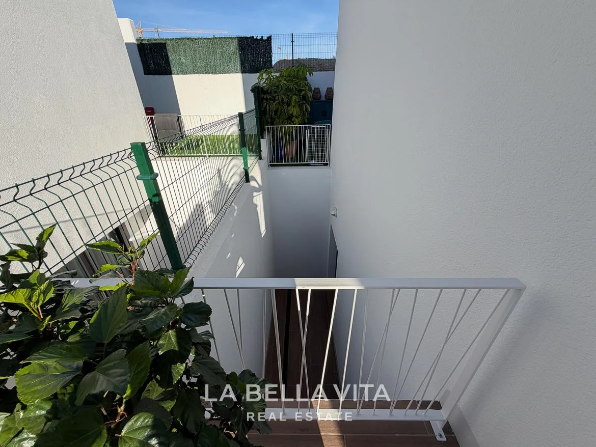Modern Resale Villa with Basement and Private Pool for Sale in Finestrat-12 Exterior stairwell leading down to the basement with white railings in Finestrat, Alicante.