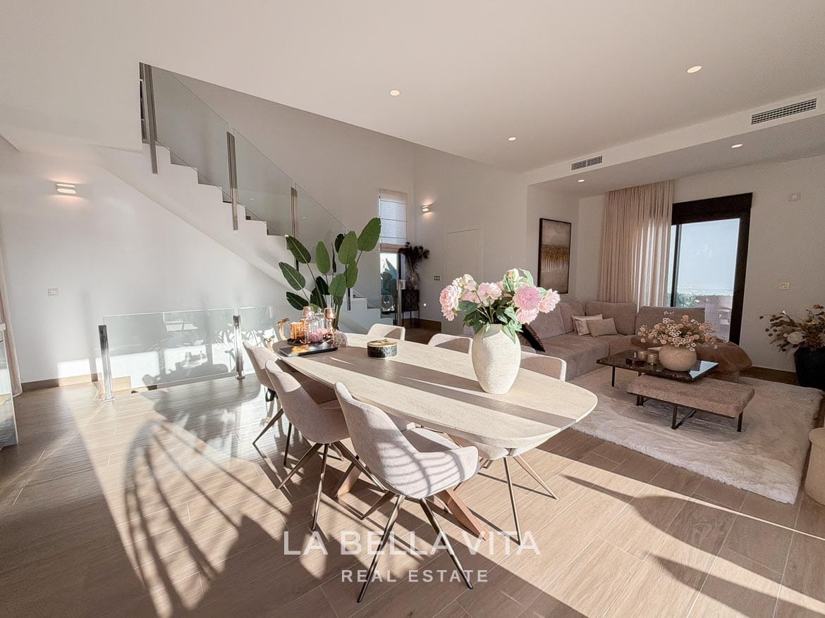 Modern Resale Villa with Basement and Private Pool for Sale in Finestrat-15 Dining table adjoining the lounge and glass-balustrade staircase in Finestrat, Alicante.
