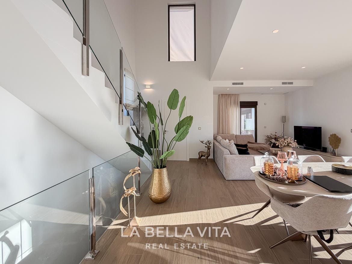 Modern Resale Villa with Basement and Private Pool for Sale in Finestrat-19 Glass-balustrade staircase beside the dining area and lounge in Finestrat, Alicante.