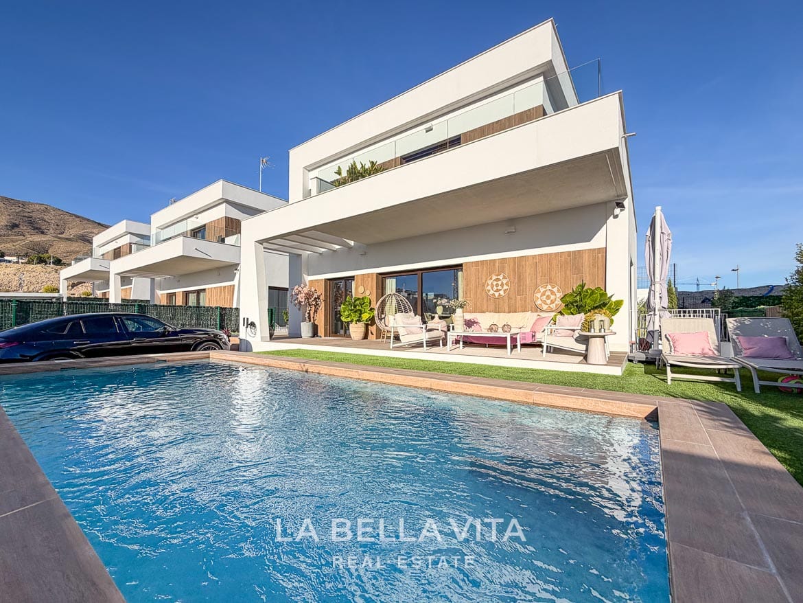 Modern Resale Villa with Basement and Private Pool for Sale in Finestrat-2 Private pool beside the white villa, covered terrace and sun loungers in Finestrat, Alicante.
