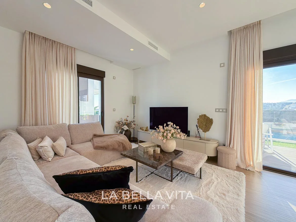 Modern Resale Villa with Basement and Private Pool for Sale in Finestrat-24 Living room with a corner sofa, coffee table, television and glazed terrace doors in Finestrat, Alicante.
