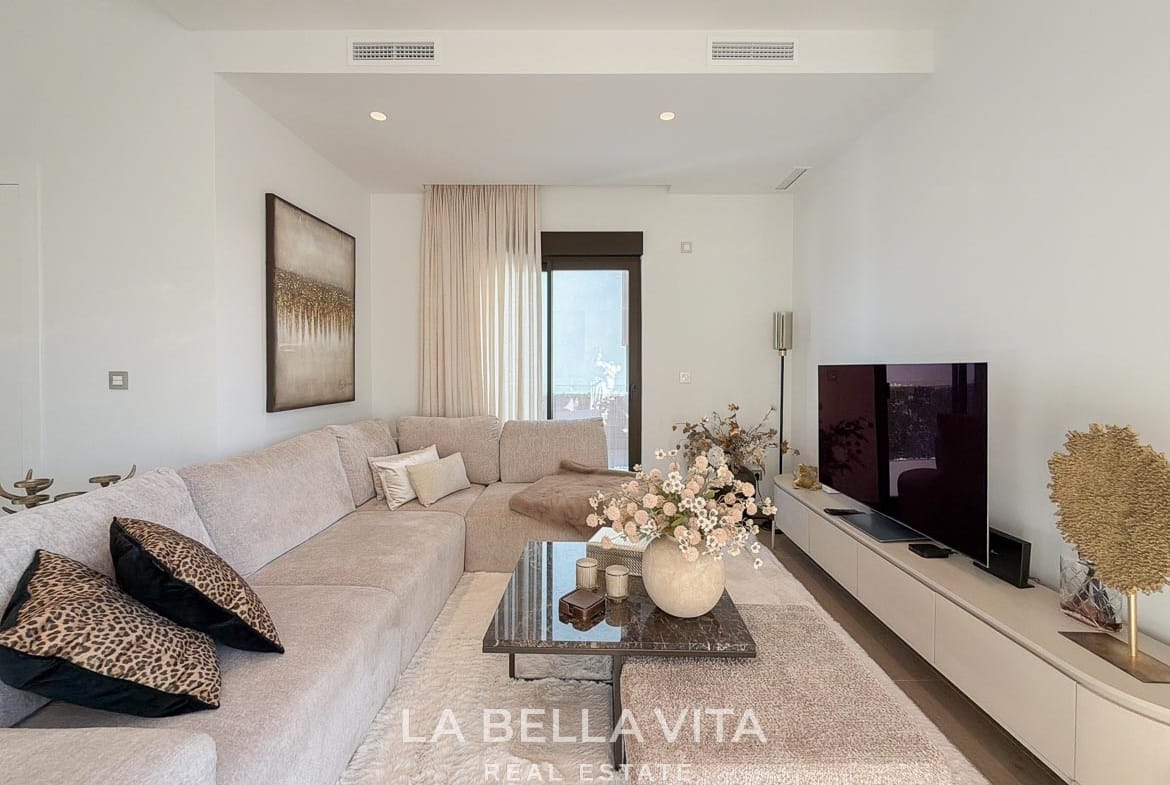 Living room seating arranged around a coffee table opposite the television in Finestrat, Alicante.