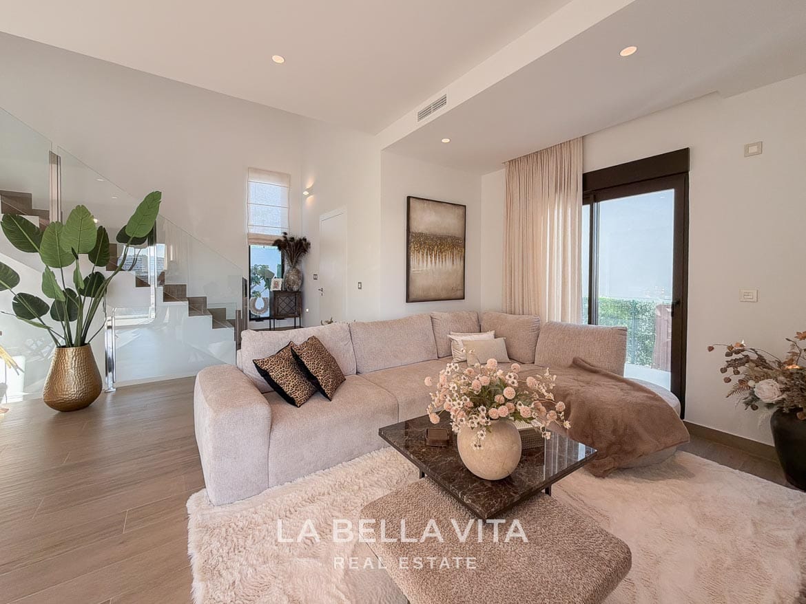Modern Resale Villa with Basement and Private Pool for Sale in Finestrat-26 Sofa with chaise longue beside the glass-balustrade staircase in Finestrat, Alicante.