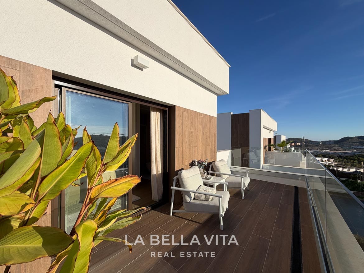 Modern Resale Villa with Basement and Private Pool for Sale in Finestrat-34 Upper terrace with two armchairs, plants and a glass balustrade in Finestrat, Alicante.