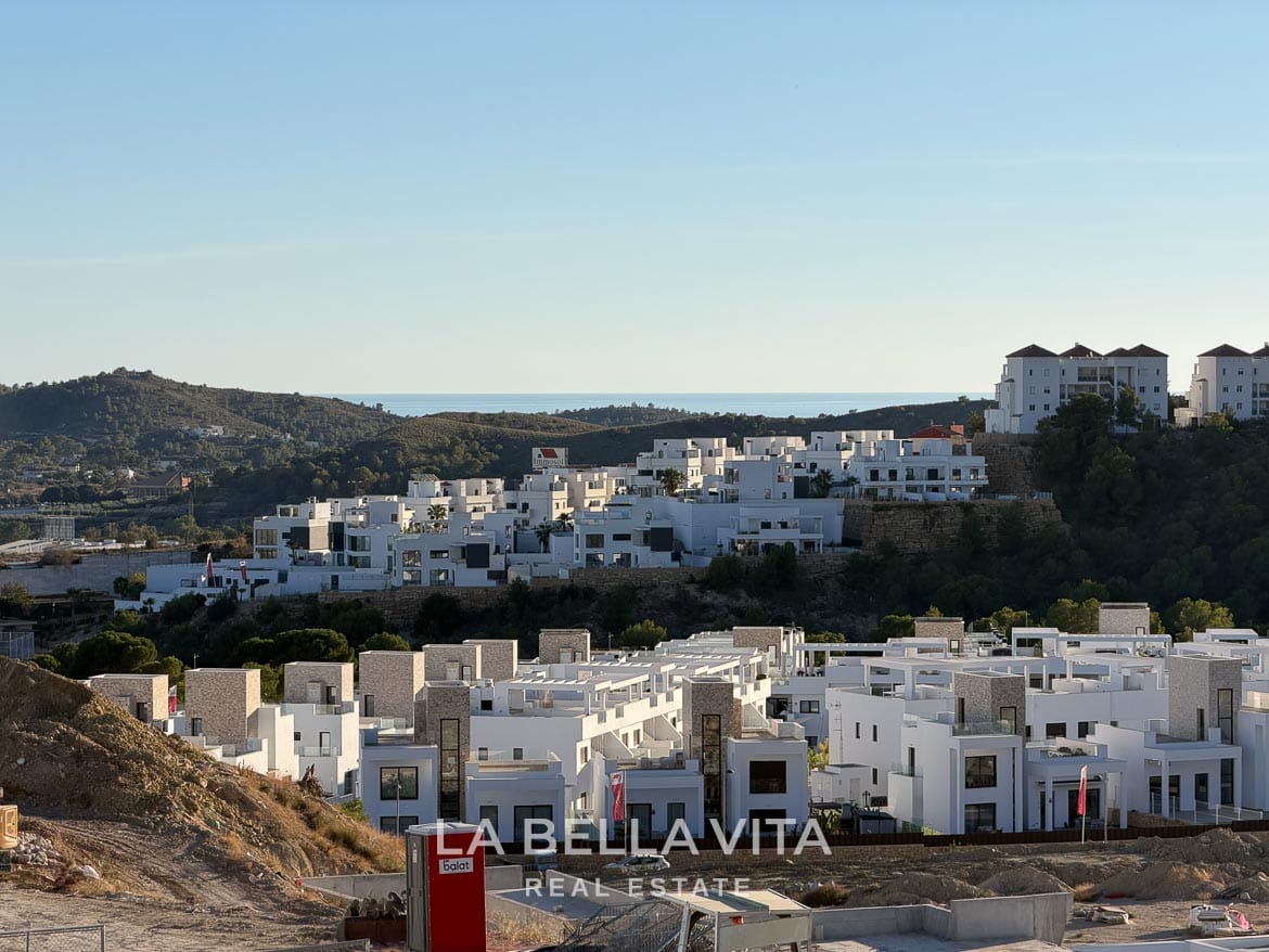 Modern Resale Villa with Basement and Private Pool for Sale in Finestrat-35 View over surrounding homes and hills towards the distant sea in Finestrat, Alicante.