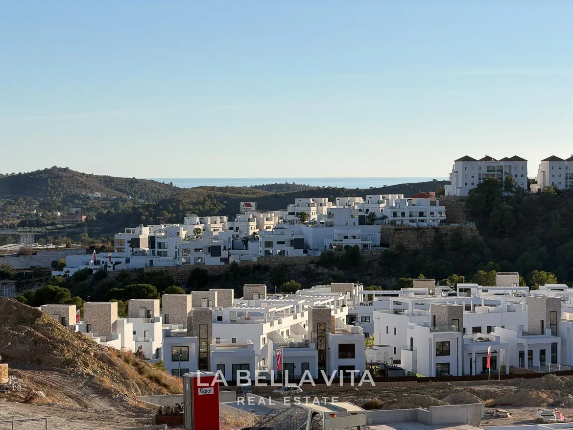 Modern Resale Villa with Basement and Private Pool for Sale in Finestrat-35 View over surrounding homes and hills towards the distant sea in Finestrat, Alicante.